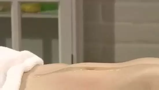 Relaxing massage scene with a man, a woman, and a bed