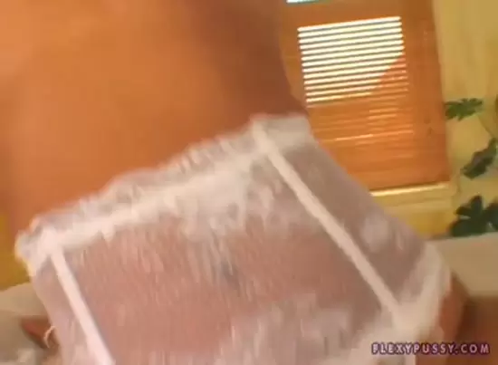 Sexy blonde woman flexes, revealing her assets